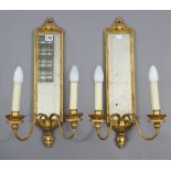 A pair of gilt frame girandoles each inset with a rectangular mirror plate & with a pair of scroll