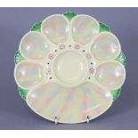 A Minton pottery oyster dish painted in pearlescent enamels, with green edging & border of pink