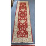A Turkish rug of crimson & cream ground with all-over repeating floral design in wide border, with a
