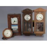 A late 19th century American wall clock with black roman numerals to the white dial, enclosed by a