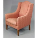 An Edwardian armchair with rounded back & sprung seat upholstered pink geometric material, & on