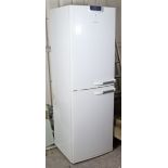 A Bosch upright fridge/freezer in a white-finish case, 23” wide x 72” high. (Interior requires clean