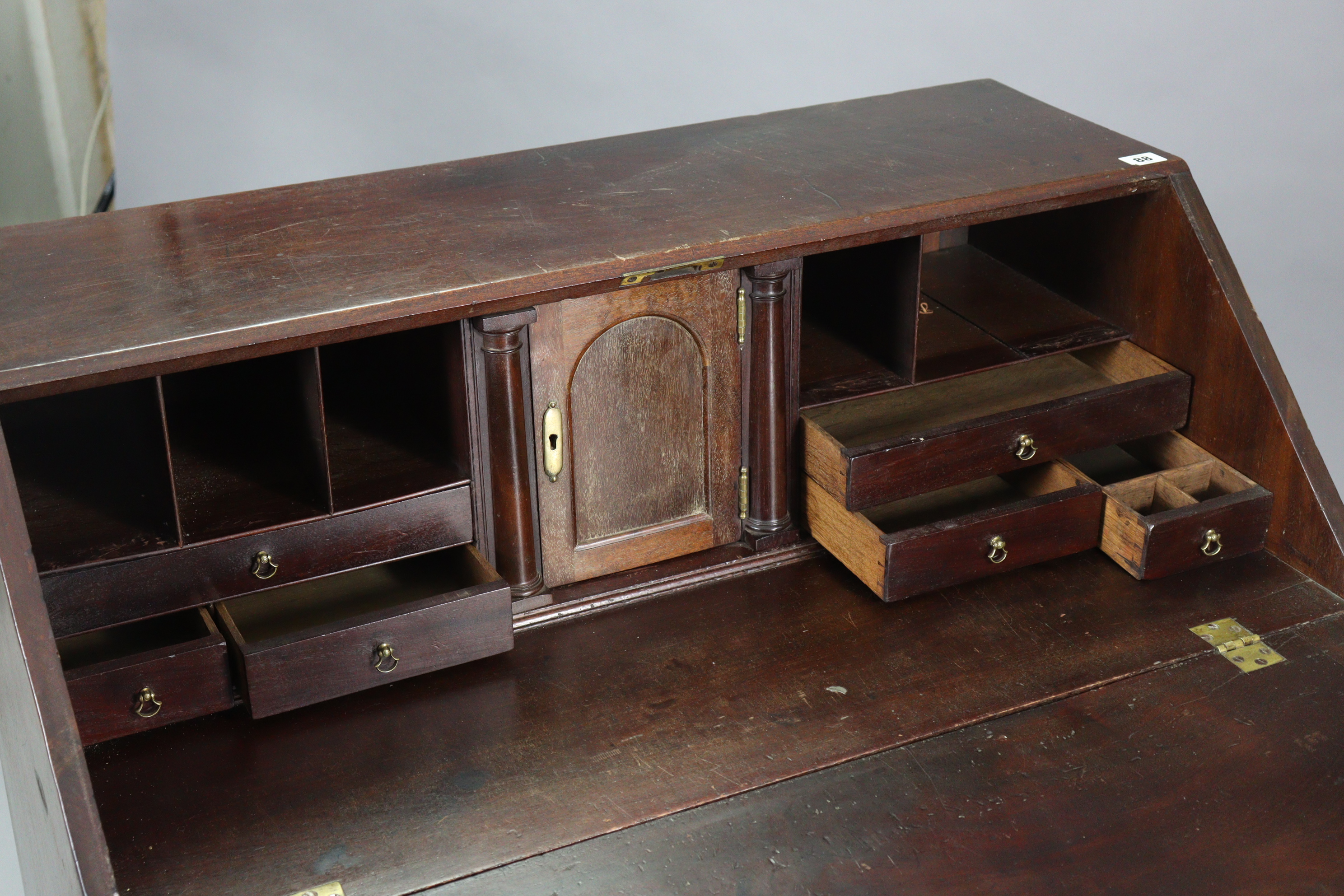 A Georgian mahogany bureau with a fitted interior enclosed by a fall-front above four long graduated - Image 3 of 8