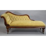 A VICTORIAN MAHOGANY-FRAME CHAISE LONGUE with a shaped back, scroll-arm, & a sprung seat upholstered