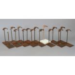 Approximately thirty vintage cast & wrought-iron milliner’s hat stands.