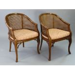 A pair of modern faux-bamboo tub-shaped chairs each inset with a woven-cane seat & back.