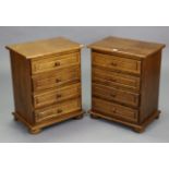 A pair of oak bedside chests, each fitted four long drawers, & on bun feet, 19¾” wide x 24¾” high.