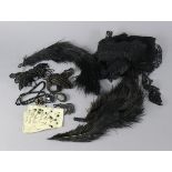 A collection of Edwardian mourning accessories including brooches, necklaces, gloves, feathers,