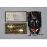 A pair of late Victorian silver-plated serving spoons with figural terminals, cased; & a carved