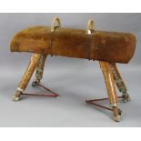 A 1930’s PINE & SUEDE GYMNASIUM POMMEL HORSE ON FOUR ADJUSTABLE LEGS, BEARS LABEL “SPENCER HEATH AND