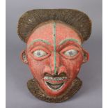 A BAMILEKE (CAMEROON) BEADED FACE MASK, of red ground with braided crest, protruding nose &