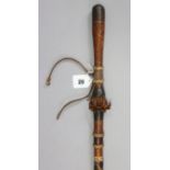 A West African leather-covered wooden walking cane, 35” tall.