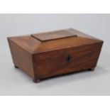 A Victorian mahogany sarcophagus-shaped work box with inlaid escutcheon & on bun feet; 11” wide x
