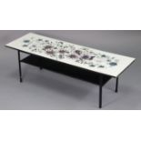 A retro-style rectangular low coffee table with floral decorated laminate top, & on square legs with