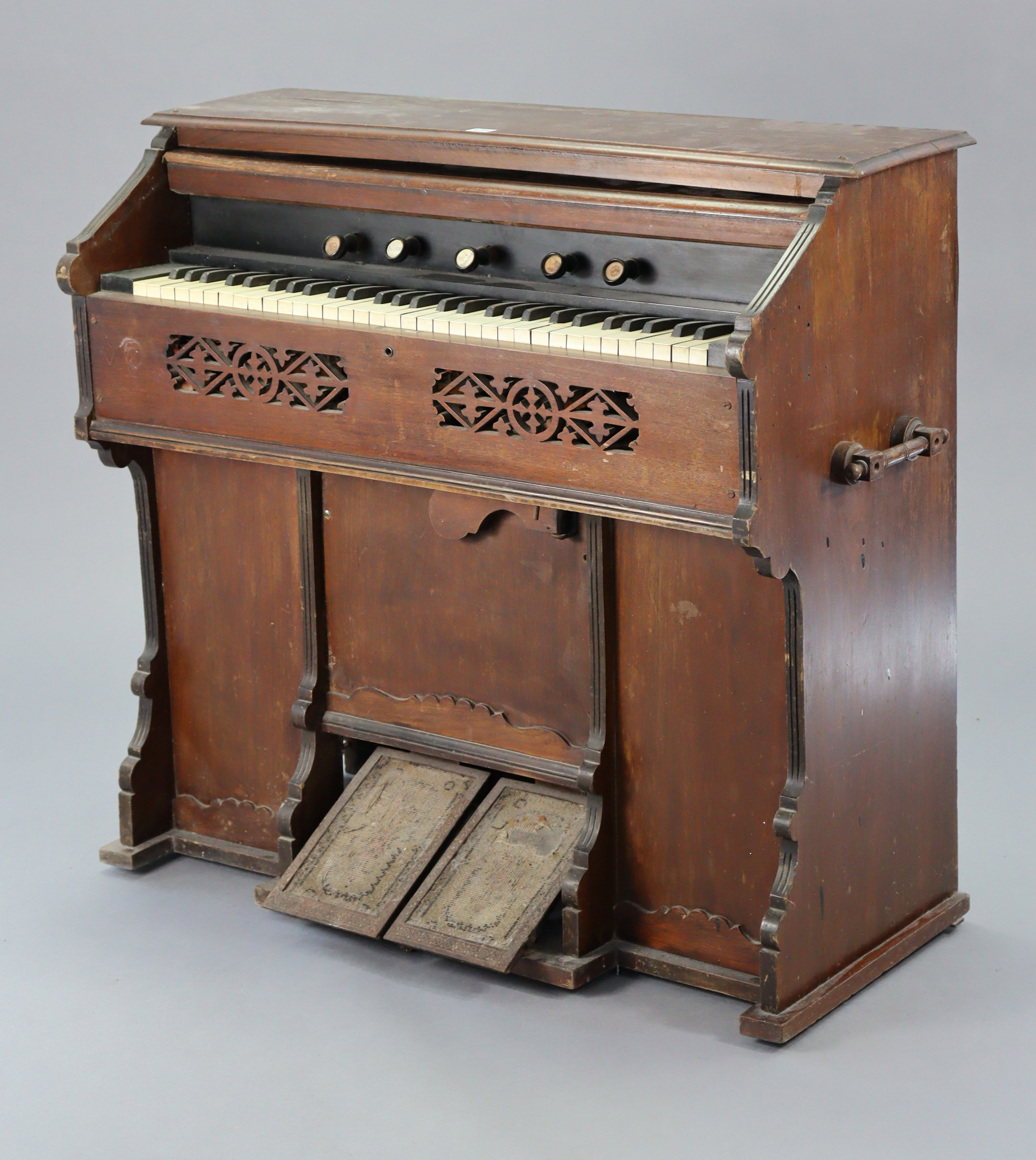 A vintage harmonium by Metzler & Co. of London in a walnut case, 41” wide x 37½” high.