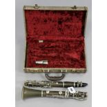 An ebonised clarinet with chrome-plated keys, 26” long, cased.