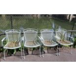 A set of four white painted wrought-metal garden chairs.