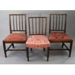 Three 19th century beech rail-back dining chairs each with a padded seat, & on square tapered legs.