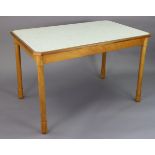 A beech-finish kitchen table inset laminate top, & on four turned legs, 44” wide x 28” high;