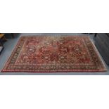 A Persian pattern small carpet of madder & ivory ground with all-over repeating multi-coloured