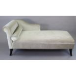 A modern chaise longue upholstered light grey velour, & on short ebonised splay legs, 65” long.