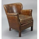A Halo brass-studded tan leather tub-shaped easy chair on short square legs.
