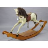 A dapple-grey painted wooden rocking horse on pine sleigh base, 70” long x 39” high.