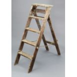 A vintage wooden four-rung folding step ladder, 52” high.