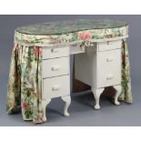 A white painted wooden kidney-shaped dressing table fitted six drawers, on short cabriole legs & pad