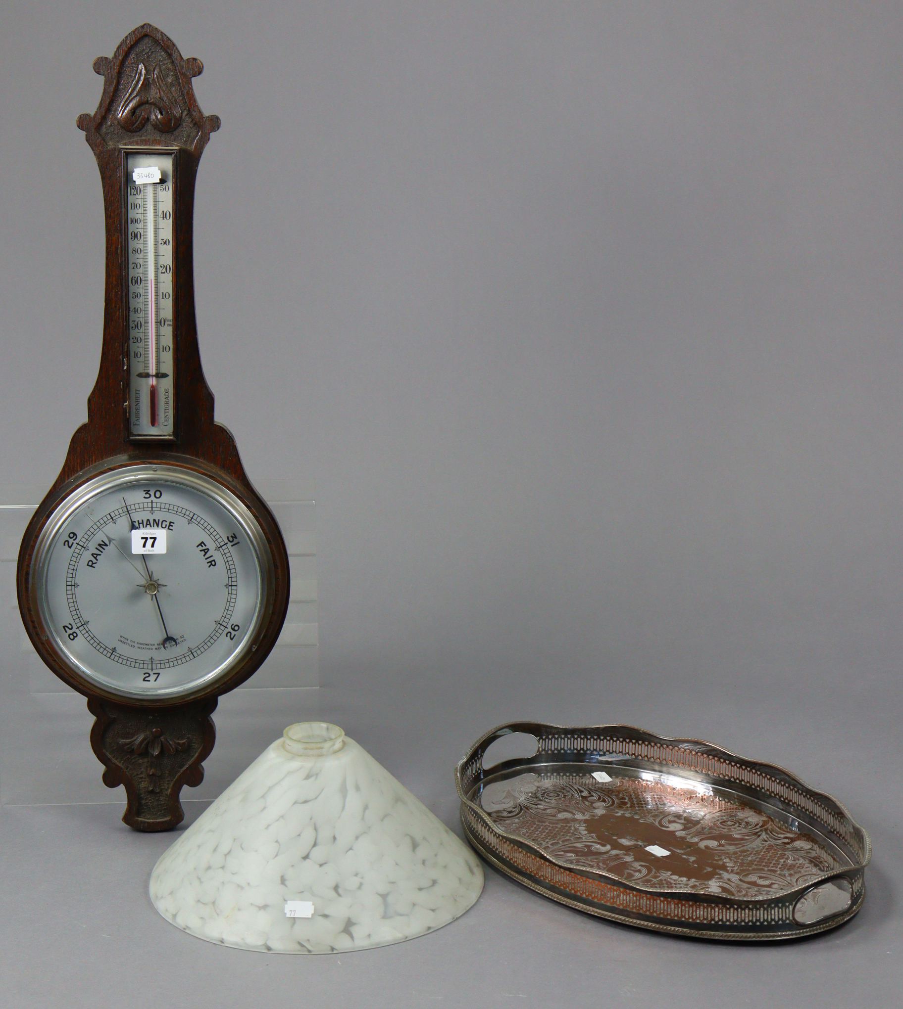 A mid-20th century wall barometer with a 7½” diameter silvered dial, & in a carved oak case, 29”