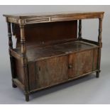A mahogany two-tier side cabinet enclosed by a pair of panel doors to the lower tier, & with