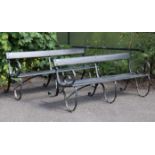 A pair of early/mid-20th century painted wooden benches on wrought-iron frames, each bearing