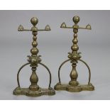 A pair of brass andirons with blauster columns on shaped rectangular platform bases, each 16¼”