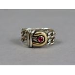 A Gucci silver ring of flexible chain links, the gilt “G” motif set synthetic ruby cabochon, size