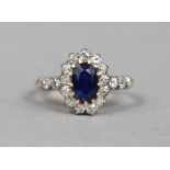 An early 20th century sapphire & diamond ring, the oval centre stone weighing approx. 1 carat, set