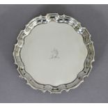 A George II silver waiter with raised pie-crust border, engraved family crest to centre, & on