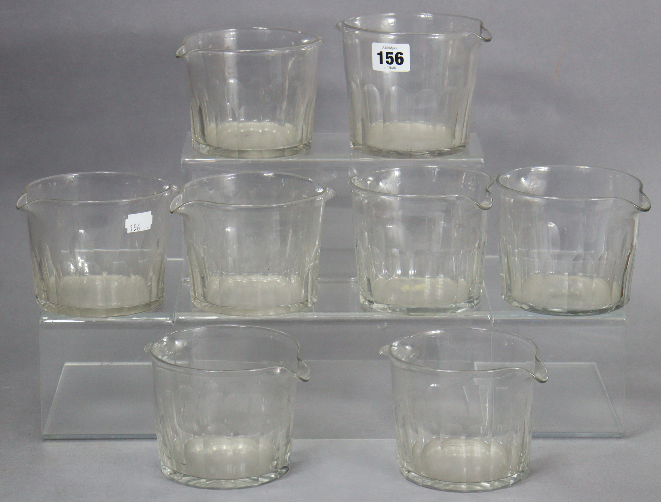 A set of eight clear cut-glass double-lipped wine glass coolers.