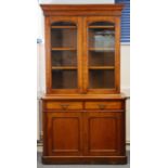 A Victorian rosewood bookcase with moulded cornice above a pair of glazed arch panel doors enclosing