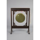 A brass dinner gong in oriental-style blind-fret carved & pierced mahogany frame on shaped end