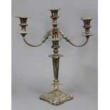 An Old Sheffield plated candelabra with detachable twin scroll arms, on round tapered column, cast