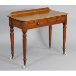 A Victorian mahogany side table by Edwards & Roberts, with raised back to the rounded rectangular