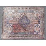 A Persian Shiraz pattern rug of ivory ground with a central lozenge & floral motifs surrounded by