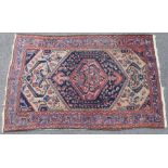 A large Hamadan rug of fawn ground with lozenge & geometric floral motifs to the centre surrounded