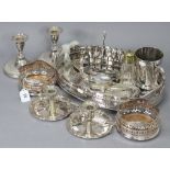 A pair of silver-plated pierced wine coasters; a pair of Elkington & Co. chamber candlesticks; an
