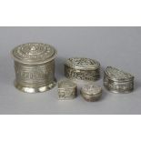 Five eastern silver boxes & covers with embossed decoration.