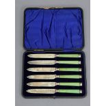 A set of six Edwardian silver dessert knives with green-stained ivory handles, London 1904, by Wm.