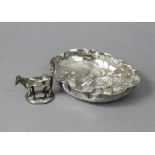 A continental silver small oval dish with shaped rim & embossed decoration of flowers & fruit,