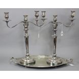 A pair of silver-plated large twin-branch candelabra with scroll arms, round tapered columns, on