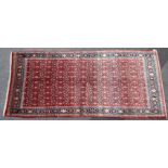 A North West Persian Bidjar rug of crimson ground with repeating geometric floral design