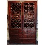 A Chinese hardwood large cabinet fitted with four long shelves enclosed
